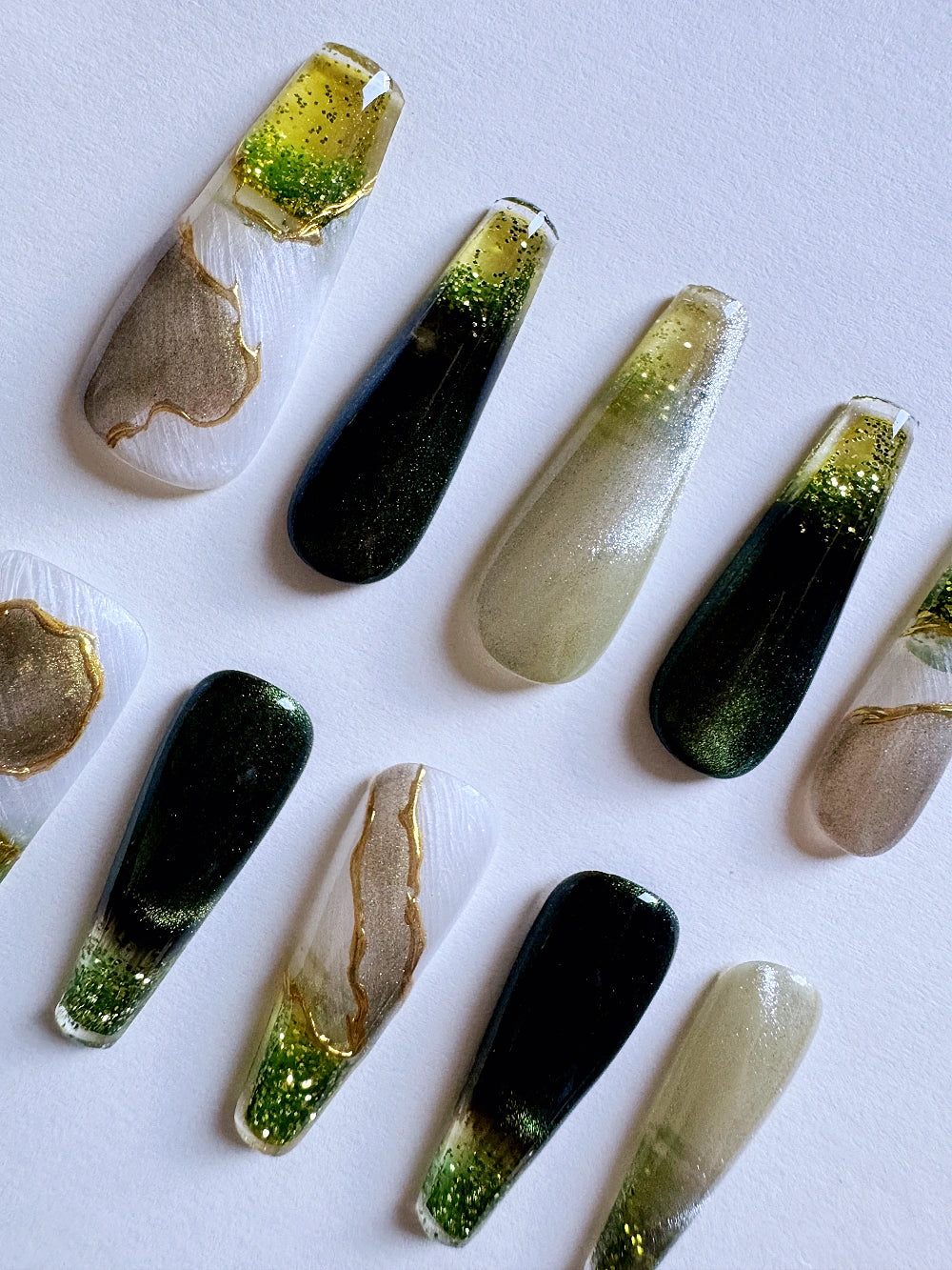 Emerald Pool Hand Drawn Elaborate Satin Gold Outline Emerald Cat Eye Flowing Sand Nail Art